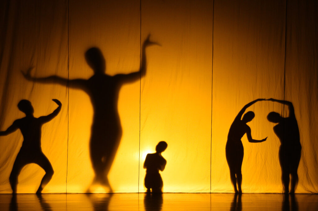 Silhouettes of dancers on a stage